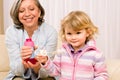 Little girl with grandmother play bubble blower Royalty Free Stock Photo