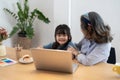 Little girl with grandmother using laptop computer, e learning on virtual online class at home. Royalty Free Stock Photo