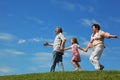 Little girl and grandparents running on hill Royalty Free Stock Photo