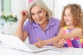 Little girl with granny using laptop Royalty Free Stock Photo