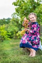 Little girl with grapes in the garden