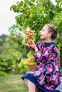 Little girl with grapes in the garden