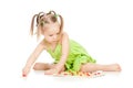 Little girl in green dress playing puzzle game