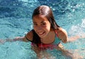 Little girl green eyes children playing at pool at tropical resort in Los Cabos Mexico