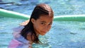 Little girl green eyes children playing at pool at tropical resort in Los Cabos Mexico