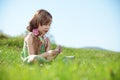 Little girl at green field