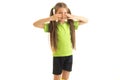 Little girl in green sports uniform hide her eyes with hands Royalty Free Stock Photo