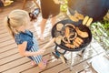 Little girl grilling the meat for the BBQ