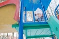 Little girl grimacing at winter outdoor playset tower