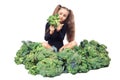 Little girl gymnast sitting among broccoli. the child looks in disgust at broccoli. isolated on white background. Royalty Free Stock Photo