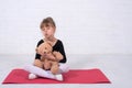 Little girl in the gymnastic swimsuit and with a teddy bear, free space