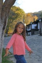 little girl, 4 and a half years old, poses as a model in a mountain village