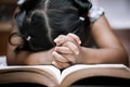 Little girl hands folded in prayer on a Holy Bible Royalty Free Stock Photo