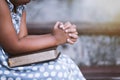 Little girl hands folded in prayer on a Holy Bible Royalty Free Stock Photo
