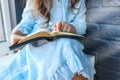 Little girl hands folded in prayer on a Holy Bible in church for faith concept in vintage color tone Royalty Free Stock Photo