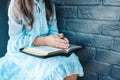 Little girl hands folded in prayer on a Holy Bible in church for faith concept in vintage color tone Royalty Free Stock Photo