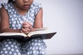 Little girl hands folded in prayer on a Holy Bible Royalty Free Stock Photo