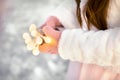 Little girl hands holding string of bokeh lights. Christmas decoration to make wish Royalty Free Stock Photo