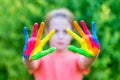 Little girl with hands painted in colorful paints ready for hand prints Royalty Free Stock Photo