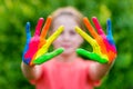 Little girl with hands painted in colorful paints ready for hand prints Royalty Free Stock Photo