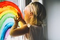 Little girl hands touch painting rainbow on window Royalty Free Stock Photo