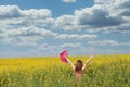 Little girl with hands up in yellow flower field spring Royalty Free Stock Photo