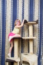 Little girl hanging on cat Climbing frame Royalty Free Stock Photo