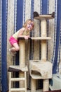 Little girl hanging on cat Climbing frame Royalty Free Stock Photo