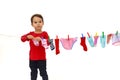 Little girl hanging her clothes to dry isolated Royalty Free Stock Photo