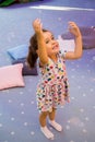 Little girl happily playing with soap bubbles at children`s party