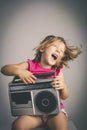 Little girl has fun listening to music Royalty Free Stock Photo