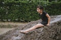 Little girl has fun with soil and mud slider in public playground and show happiness with smiling Royalty Free Stock Photo