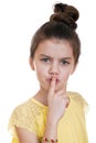 Little girl has put forefinger to lips as sign of silence Royalty Free Stock Photo