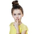 Little girl has put forefinger to lips as sign of silence Royalty Free Stock Photo