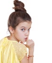 Little girl has put forefinger to lips as sign of silence Royalty Free Stock Photo