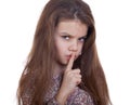 Little girl has put forefinger to lips as sign of silence Royalty Free Stock Photo