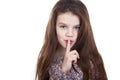 Little girl has put forefinger to lips as sign of silence Royalty Free Stock Photo