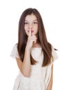 Little girl has put forefinger to lips as sign of silence Royalty Free Stock Photo