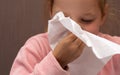 Sick girl child sneezes in a napkin Royalty Free Stock Photo