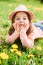 Little girl with hat lying on the grass Royalty Free Stock Photo