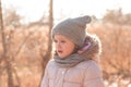 Little girl in a hat and a scarf for a walk in the autumn park Royalty Free Stock Photo