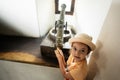 Little girl in a hat and a yellow T-shirt with a vintage cannon in castle Royalty Free Stock Photo
