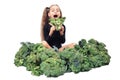 Little girl have fun holding broccoli head and biting her