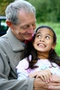 A little girl having fun with her grandfather