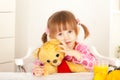 Little girl having fun with plush bear toy Royalty Free Stock Photo