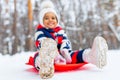 little girl having fun and sledding sled playing in snowy park