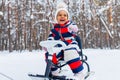 little girl having fun and sledding sled playing in snowy park