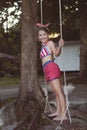 Little girl having fun on tire swing on summer day Royalty Free Stock Photo