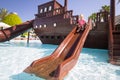 Little girl having fun at the water slide on summer holidays Royalty Free Stock Photo