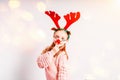 Little girl having fun wearing Christmas party glasses with reindeer antlers and red nose.Little girl in a Christmas Royalty Free Stock Photo